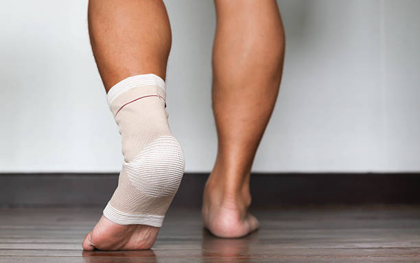 istock Injured ankle and foot wrapped in bandage 485564210