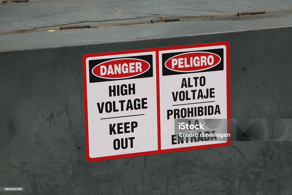 Warning Sign In English And Spanish An electrical warning sign in both English and Spanish Spanish Language Stock Photo