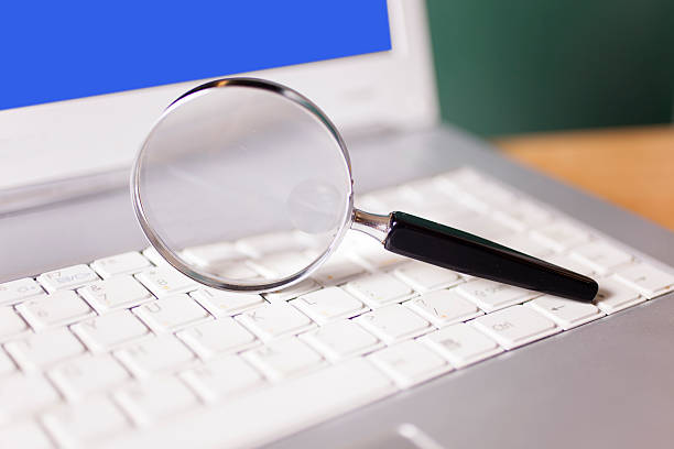 istock Business concepts. Round magnifying glass on laptop computer keyboard. 485565368
