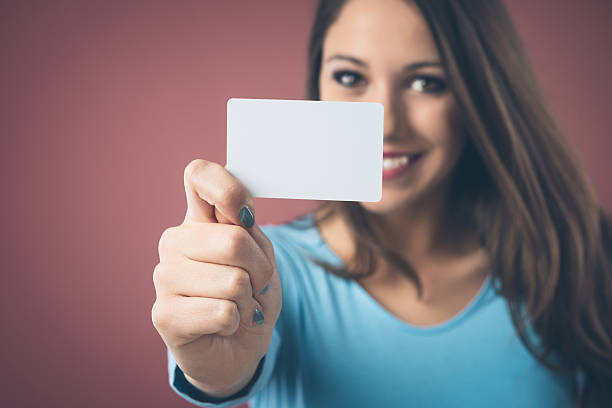 istock Smiling girl with business card 485569578