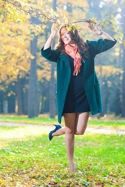 istock Smiling Female Model Standing In Fall Forest Outdoors 485569606