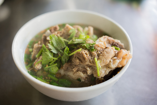 A soup with herbs , meat and pork bones. In some Asian countries, people often eat it with noodles or rice.