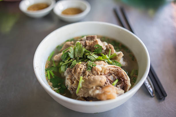 A soup with herbs , meat and pork bones. In some Asian countries, people often eat it with noodles or rice