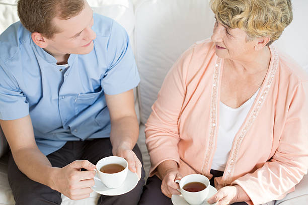 istock Man drinking tea with mature woman 485570714