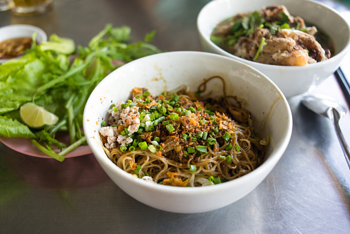Pho is extremely popular in Vietnam. However, another noodle dish, this one called Hu Tieu Nam Vang, might be equally as popular, and widely available everywhere you look throughout Saigon.