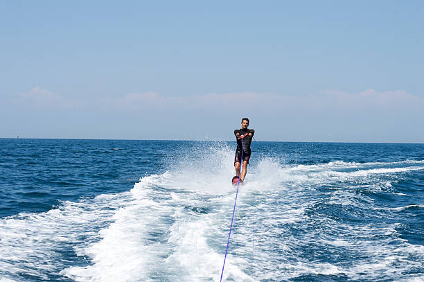 istock Attractive young man is skiing on water 485570930