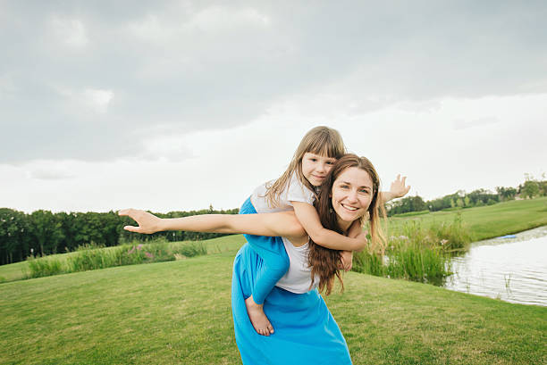 Mom and her little girl enjoying their vacation in the pool (shallow dof)