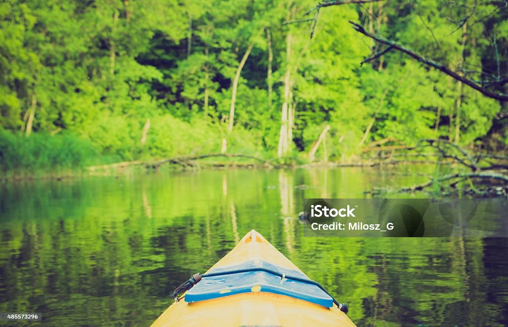 Vintage photo of kayaking by Krutynia river in Poland Vintage photo of beautiful Krutynia river landscape photographed from kayak. Photo with vintage mood effect 2015 Stock Photo