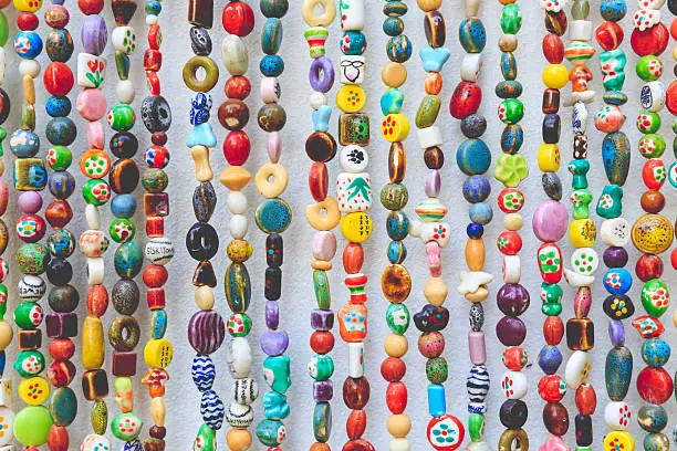 colorful stone beads hanging on wall background