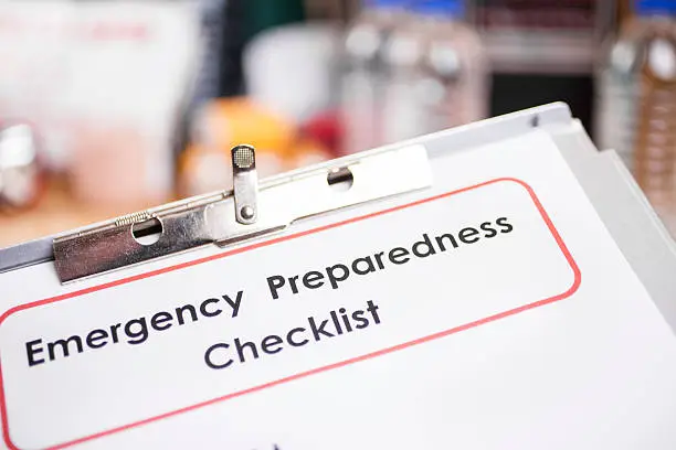 Photo of Emergency preparedness checklist and natural disaster supplies.