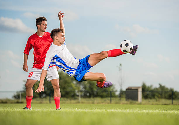 Two football player man in action on dark arena background
