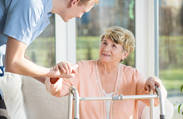 istock Man helps to stand up an older woman 485577290