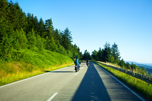 Seebach, Germany - July 10, 2015: Shot of two bikers on road B 500 Schwarzwaldhöhenstraße on way to south at midsummer sunset light. Scene is close to lake Mummelsee.