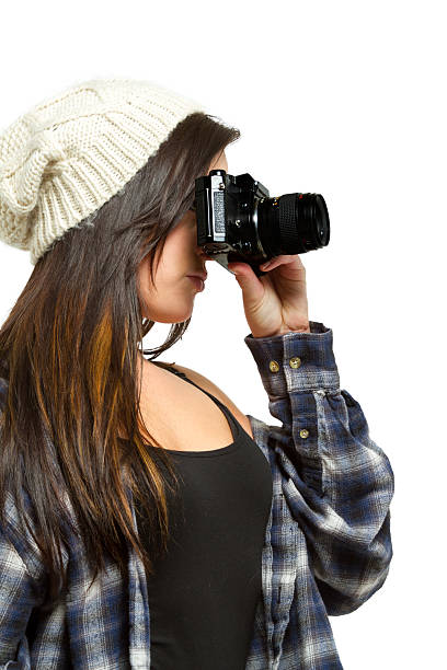 istock Young woman with brown hair holds camera 485581939