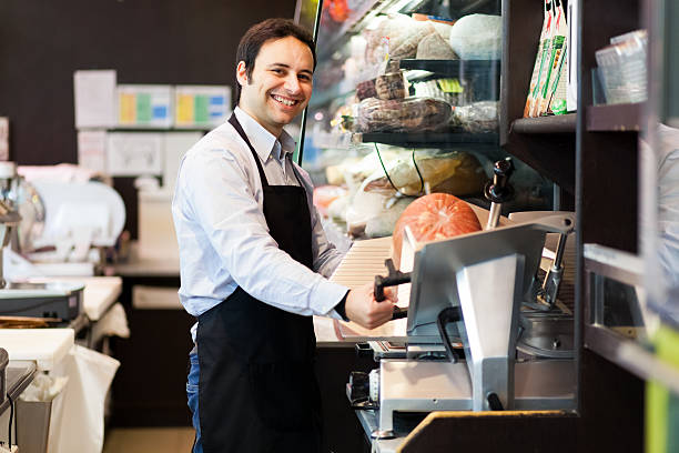 istock Shopkeeper cutting ham in a grocery store 485581988