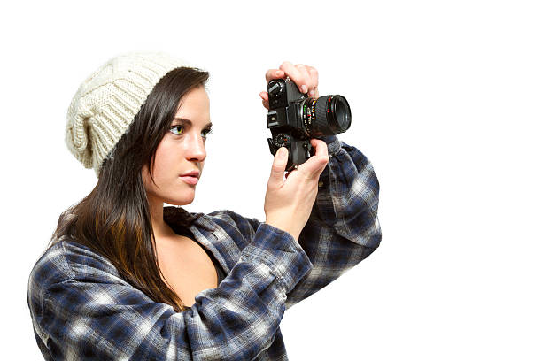 istock Young woman with brown hair holds camera 485581997