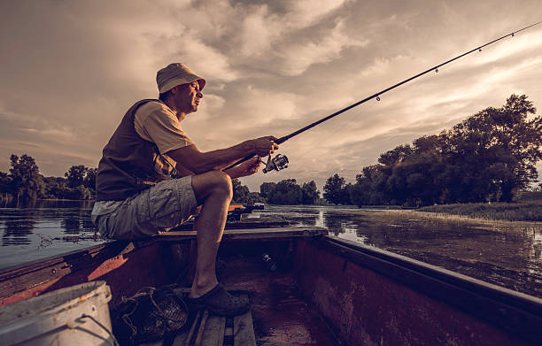 istock Man spending a day in river fishing from boat. 485586954