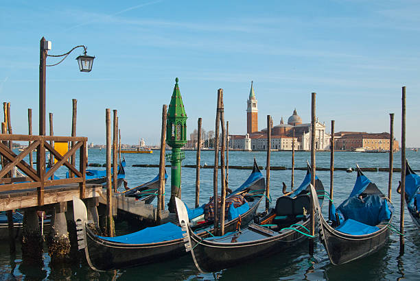 istock Gondalas moored on a quay in Venice, Italy 485588084