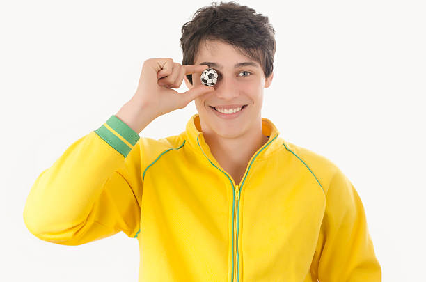 Young man with a small football ball.