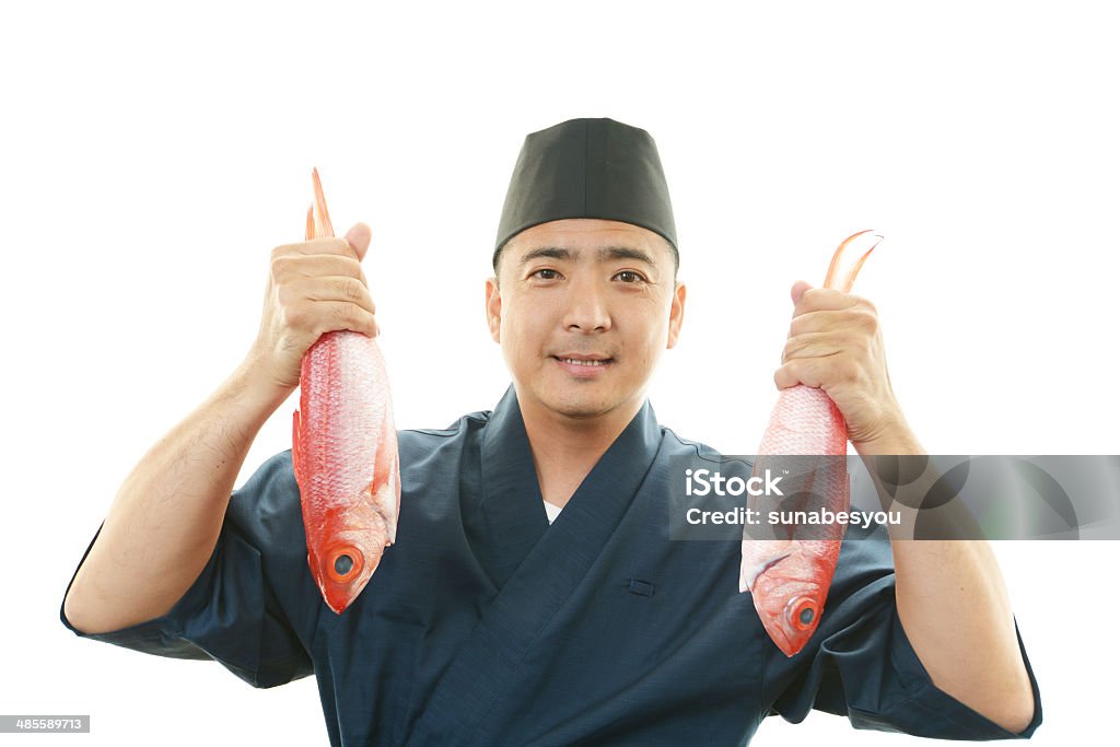 Portrait of a Japanese chef Portrait of a Japanese chef holding fish Adult Stock Photo