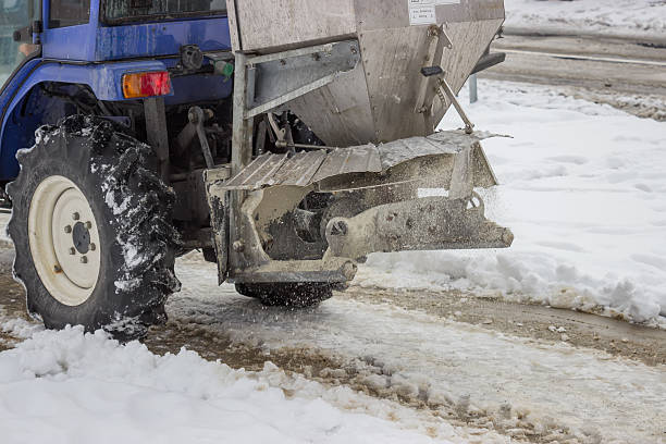 istock Sprinkling salt on a sidewalk after snowfall 2 485590071