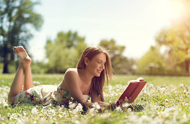 istock Happy woman enjoying in spring day and reading a book. 485598138