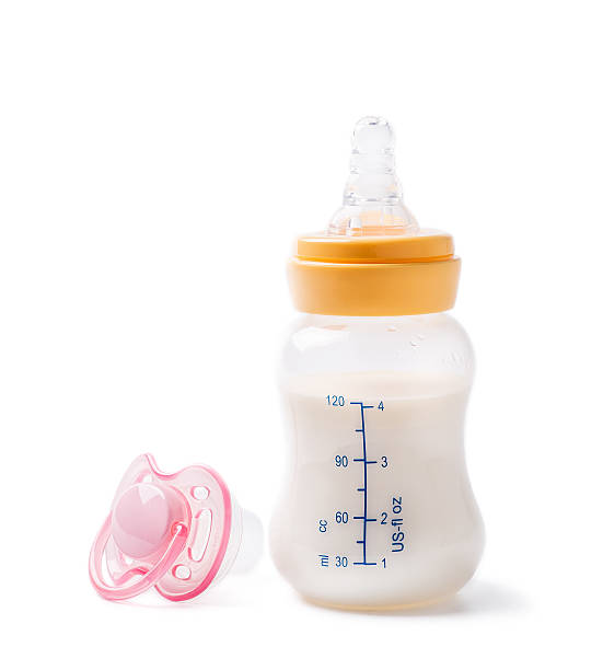 Milk bottle for baby feeding and dummy stock photo