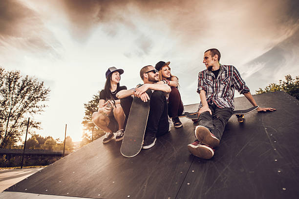 istock Below view of smiling friends communicating at skate park. 485607886
