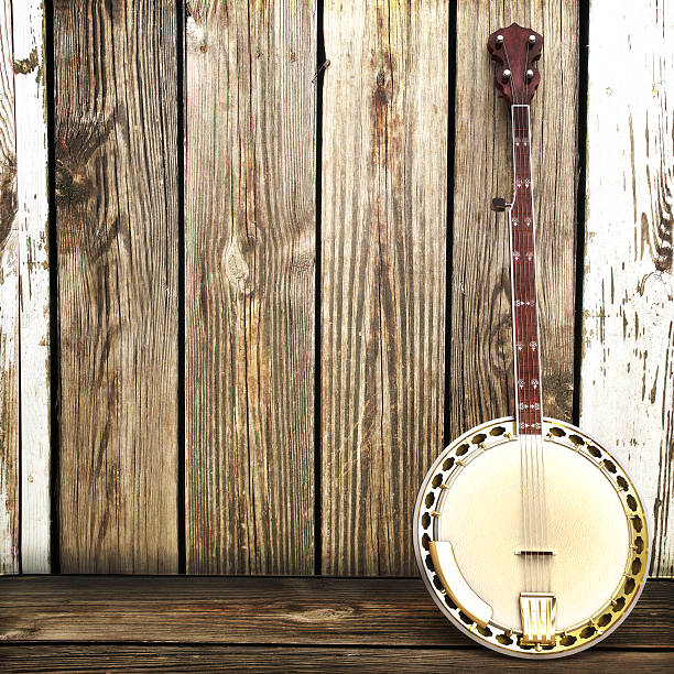 Banjo leaning on a wooden fence  Advertisement with room for text or copy space.  banjo stock pictures, royalty-free photos & images