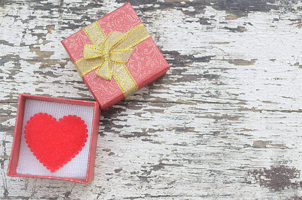 istock Red heart in gift box on grunge wood 485611322