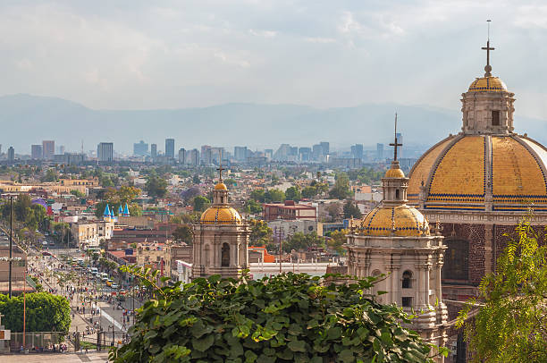 Old Basilica of Guadalupe Old Basilica of Guadalupe with Mexico City skyline behind it mexico city stock pictures, royalty-free photos & images