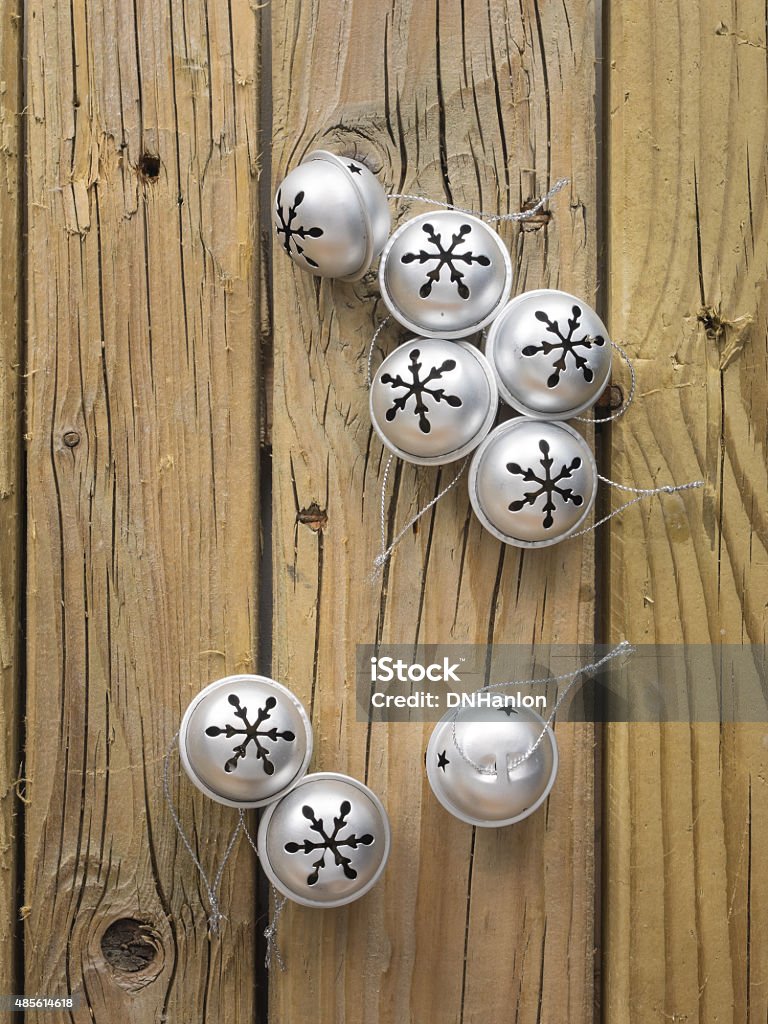 jingle bells silver sleigh bells against rustic old wooden background Backgrounds Stock Photo