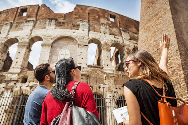 Guide explaining to tourists the Coliseum of Rome stock photo