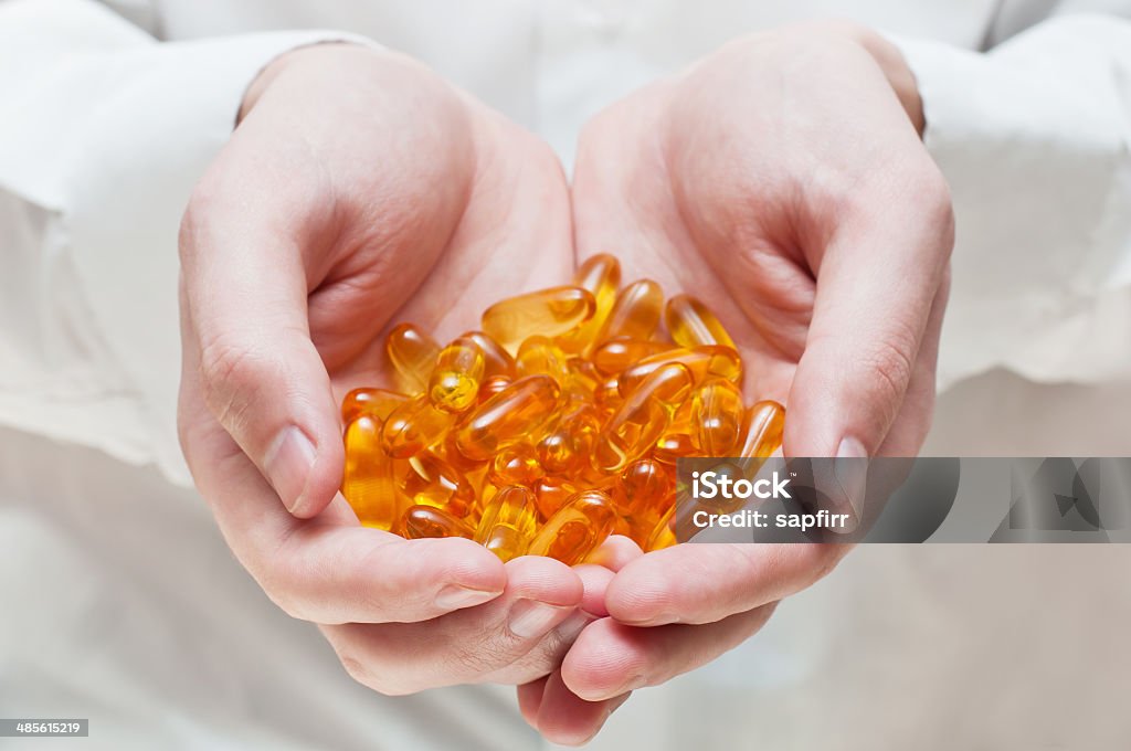 Omega-3 capsules Doctor's hand with gel capsules. Omega-3 fish oil Acid Stock Photo