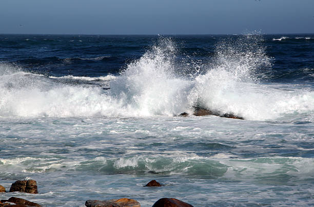 The ocean pounds the shoreline at the Cape Of Good Hope, at the southern tip of the African continent.