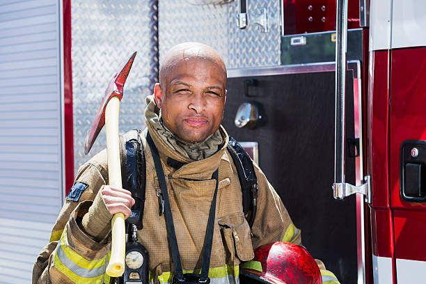 istock African American fire fighter carrying axe 485616542