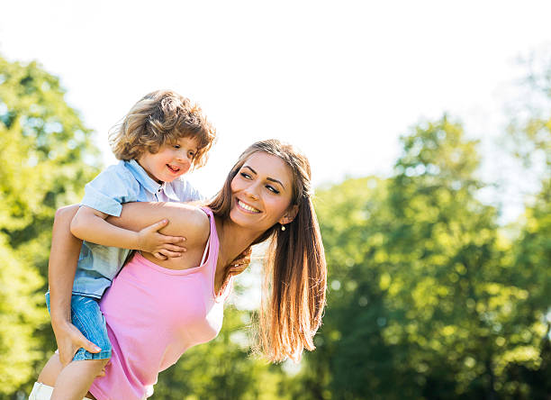 istock Happy mother piggybacking her son in nature. 485616852