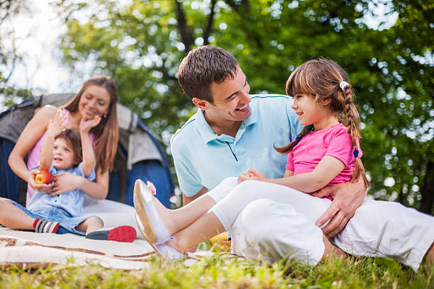 istock Happy father communicating with his daughter on camping. 485616880