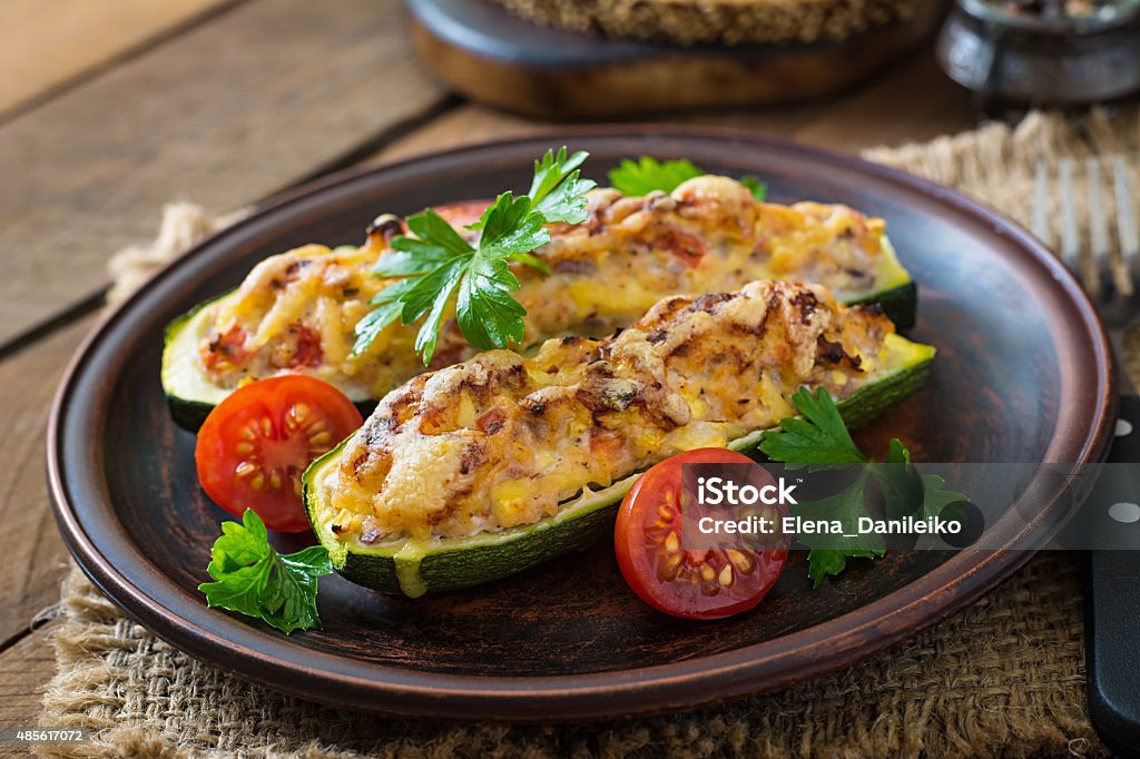 Stuffed zucchini with chicken, tomatoes and onion with cheese crust Zucchini Stock Photo