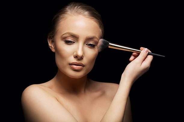 istock Sensual young woman applying make up 485617231