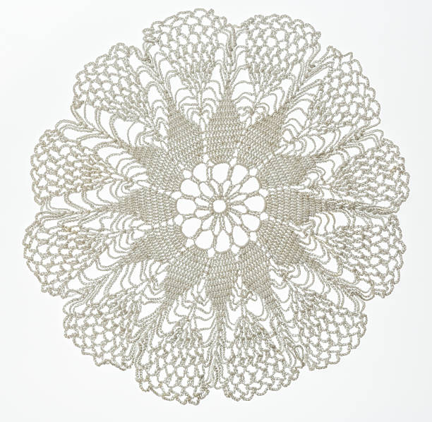 Crocheted lace on white Crocheted lace napkin as home decoration on white lace doily crochet craft product stock pictures, royalty-free photos & images