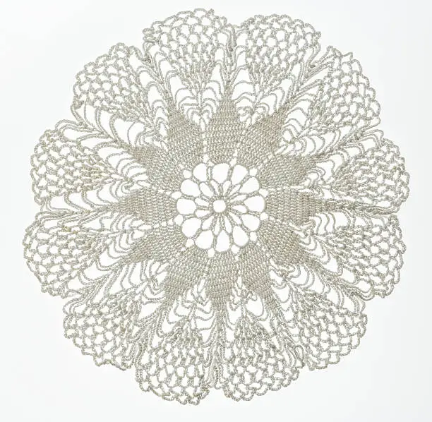 Crocheted lace napkin as home decoration on white