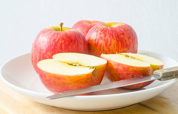 istock Red apples and apple slices on a white dish 485618222