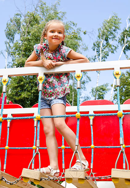 istock Smiling little girl playing on playground equipment 485620002
