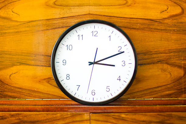 istock Clock standing on orange furniture 485624128
