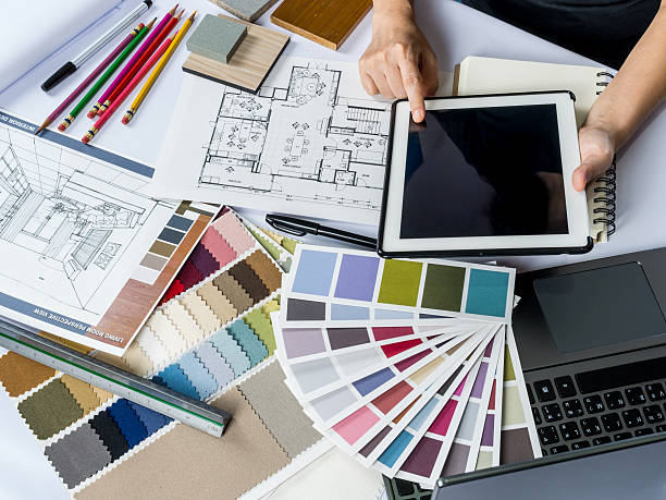 Architects/ interior designer hands working with tablet computer, material sample stock photo