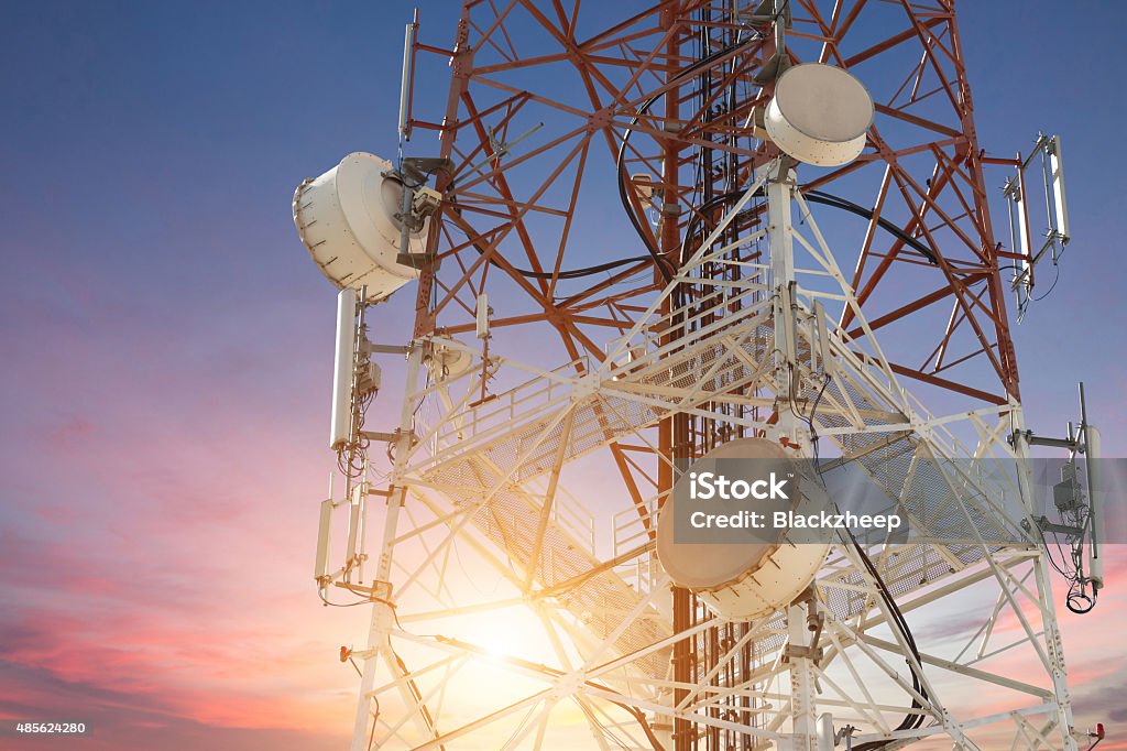 Satellite dish telecom tower at sunset Communications Tower Stock Photo