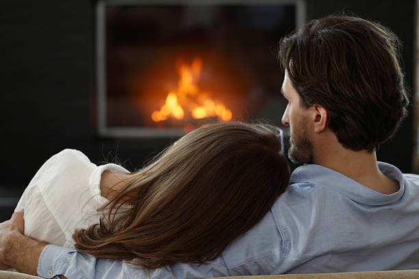 istock couple next to the fireplace 485628576