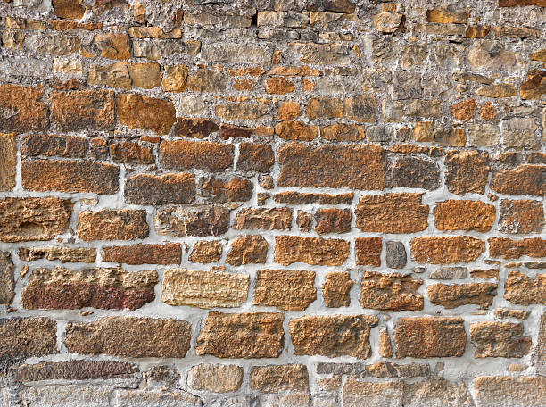 istock Old wall made of rough brown stones 485629270
