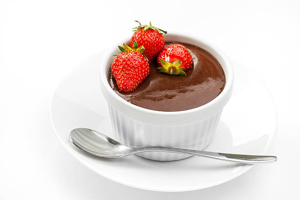 Chocolate mousse with strawberries in white cup on plate stock photo